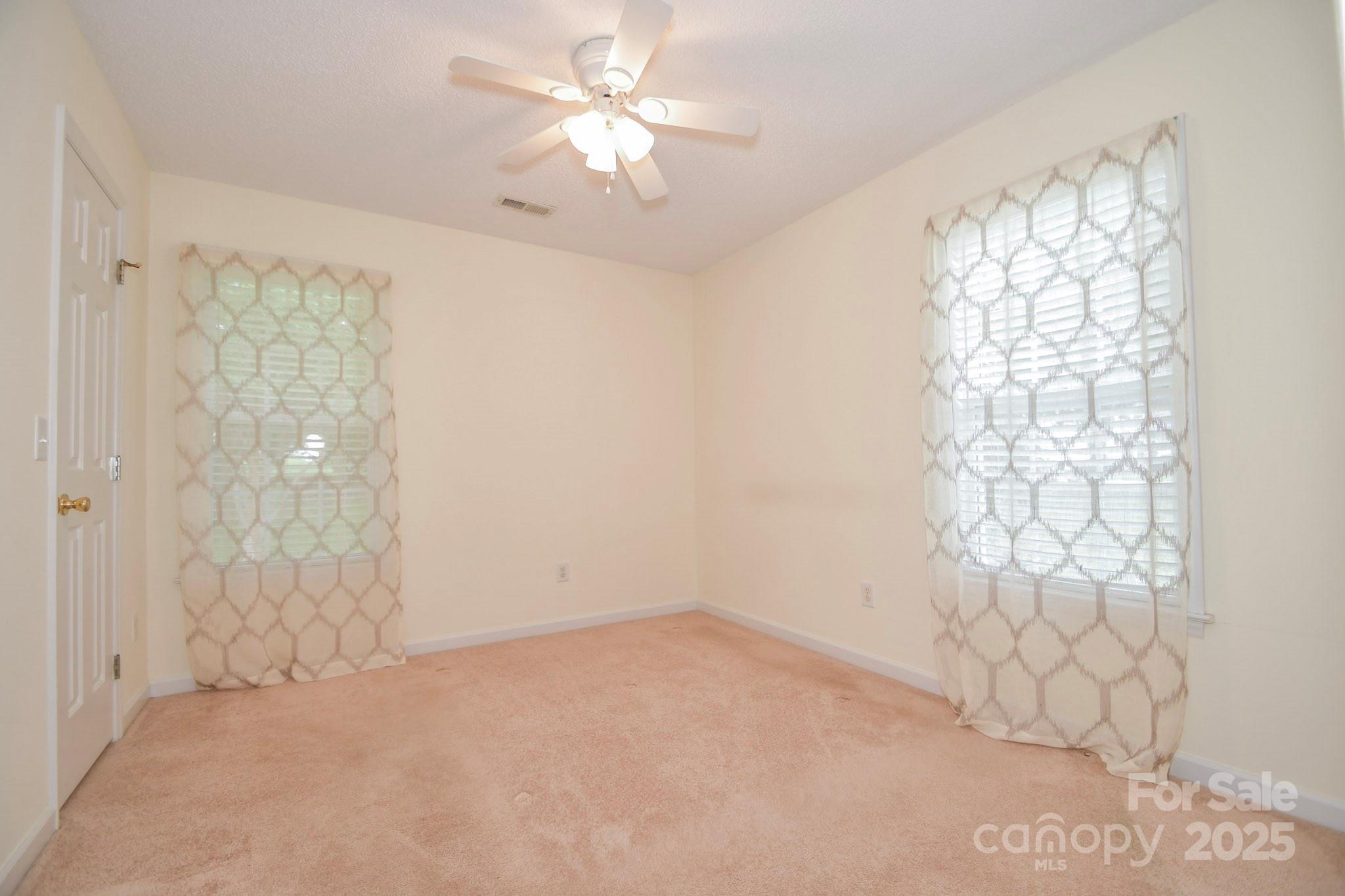 2718 Goldmine Road Monroe, NC 28110 - Photo 21 of 25 an empty room with windows and closet