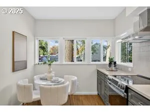 a bathroom with a granite countertop sink a large mirror a and a window