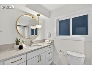 a bathroom with a sink mirror and vanity