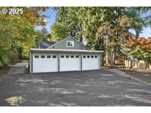 a view of a house with a yard and a large tree