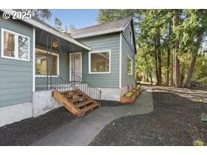 a backyard of a house with barbeque oven table and chairs