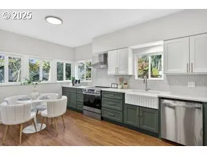 a kitchen with a table chairs sink and cabinets
