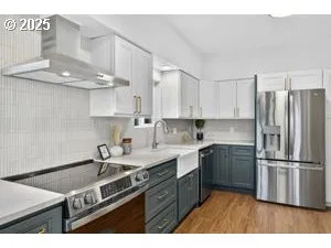 a kitchen with stainless steel appliances granite countertop a sink stove and refrigerator
