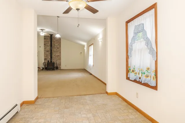 a view of a big room with closet and windows