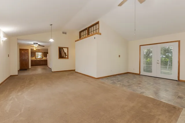 a view of a hallway to rooms and wooden floor