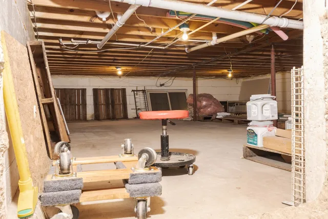 a backyard of a house with barbeque oven table and chairs