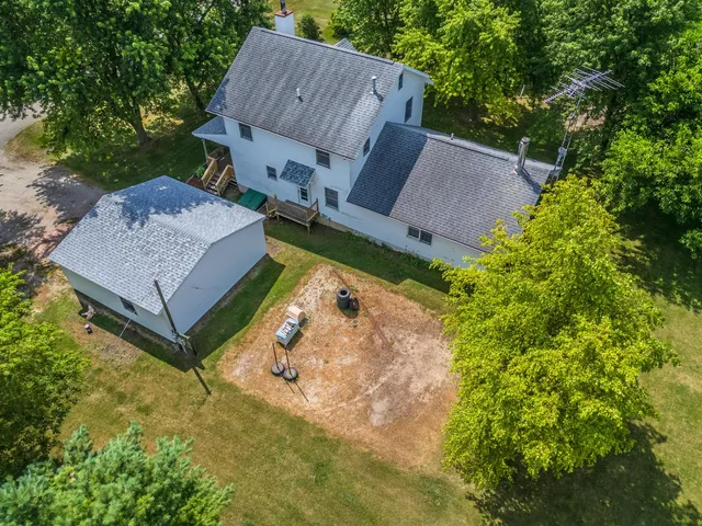 an aerial view of a house with garden space and street view