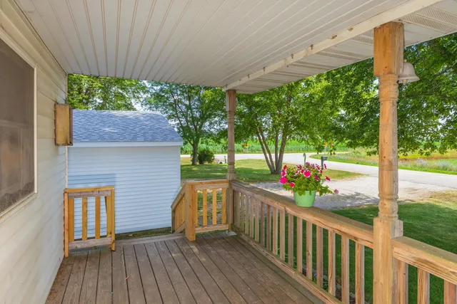 a porch with seating space and hardwood floor