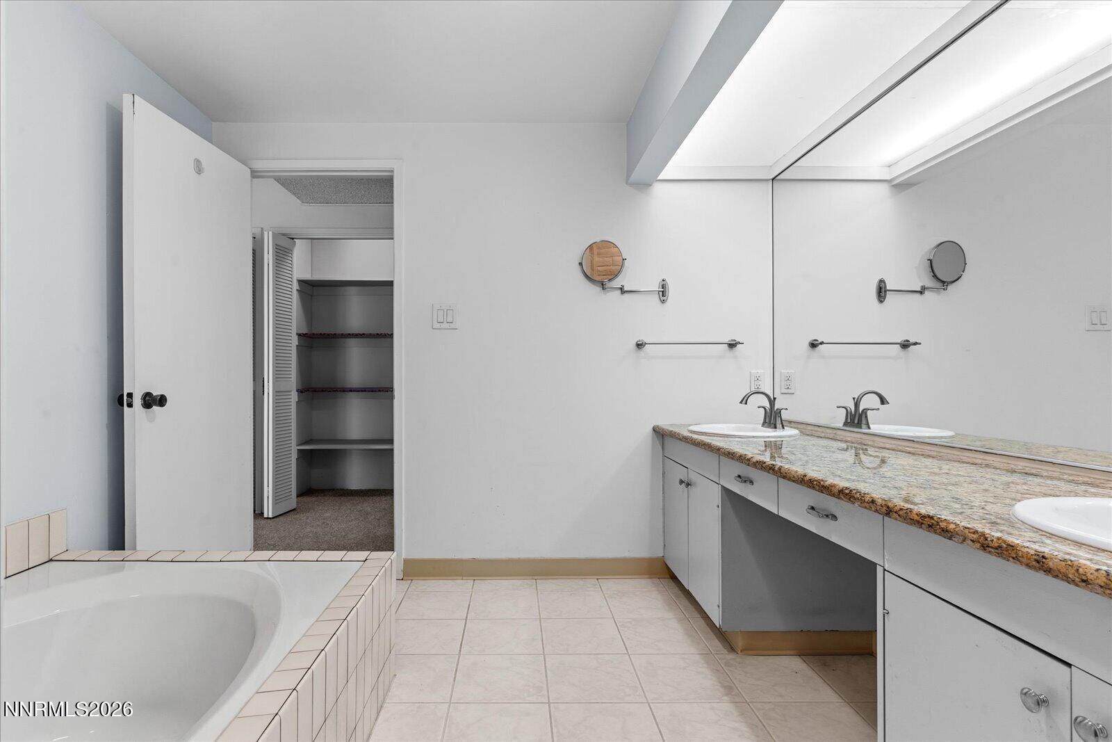 1200 Riverside Drive, Unit 1229 Reno, NV 89503 - Photo 38 of 51 a spacious bathroom with a granite countertop sink and a bathtub
