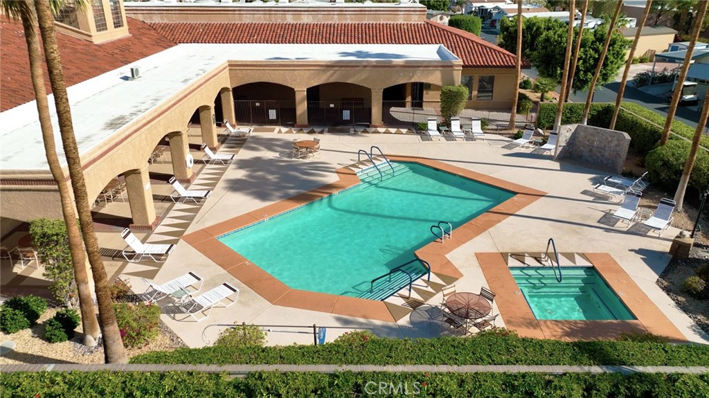 69801 Ramon Road, Unit 57 Cathedral City, CA 92234 - Photo 15 of 47 a view of a white house with a yard and sitting area