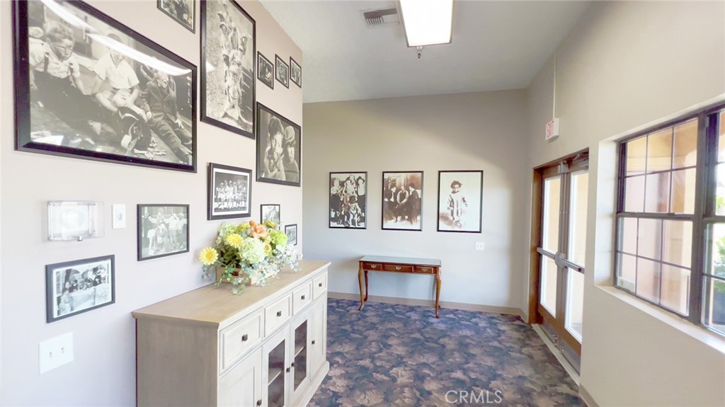 69801 Ramon Road, Unit 57 Cathedral City, CA 92234 - Photo 36 of 47 a hallway with painting and wooden floor