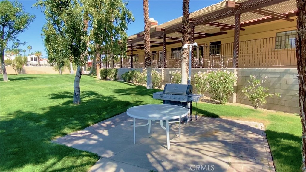 69801 Ramon Road, Unit 57 Cathedral City, CA 92234 - Photo 39 of 47 a view of a patio with a table and chairs