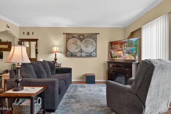 a view of a dining room with furniture and wooden floor