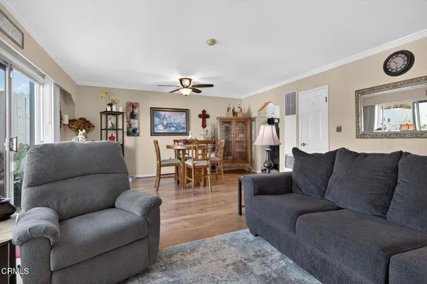 a view of a dining room with furniture and wooden floor