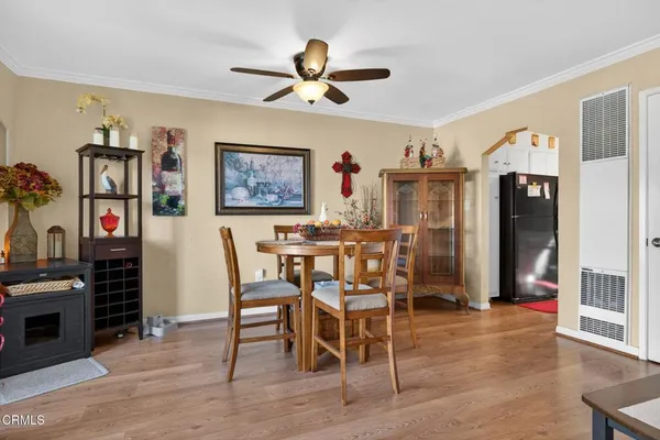 a view of a dining room with furniture wooden floor and chandelier