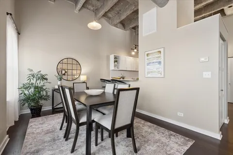 a view of a dining room with furniture and a potted plant