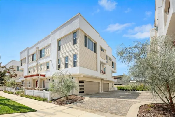 a front view of a residential apartment building with a yard