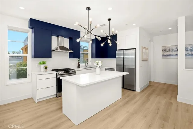 a kitchen with a sink appliances and cabinets