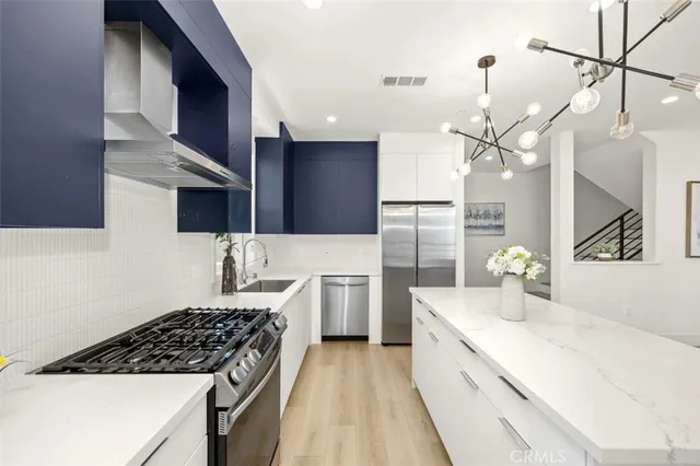 a kitchen with a sink stainless steel appliances and cabinets