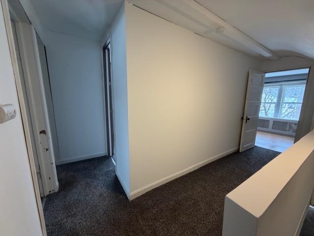 824 12th Street North Virginia, MN 55792 - Photo 21 of 34 Hallway with dark colored carpet and baseboards