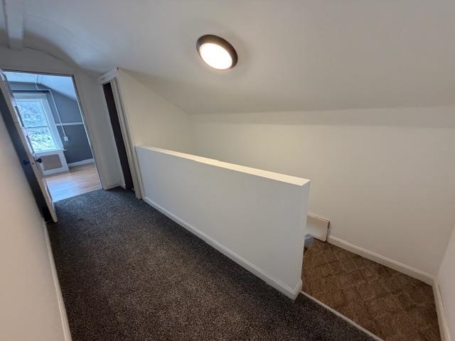 824 12th Street North Virginia, MN 55792 - Photo 25 of 34 Corridor featuring lofted ceiling, carpet floors, and an upstairs landing