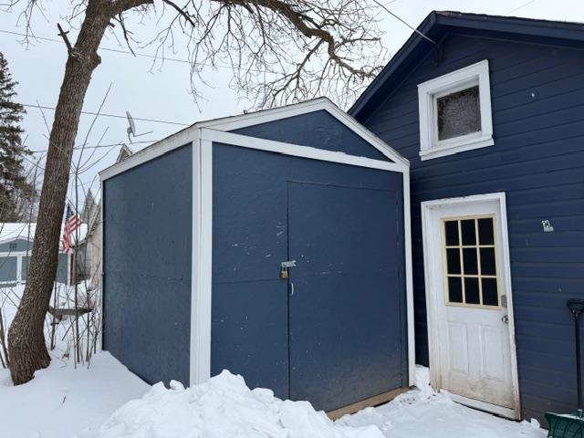 824 12th Street North Virginia, MN 55792 - Photo 34 of 34 Snow covered structure featuring a storage shed