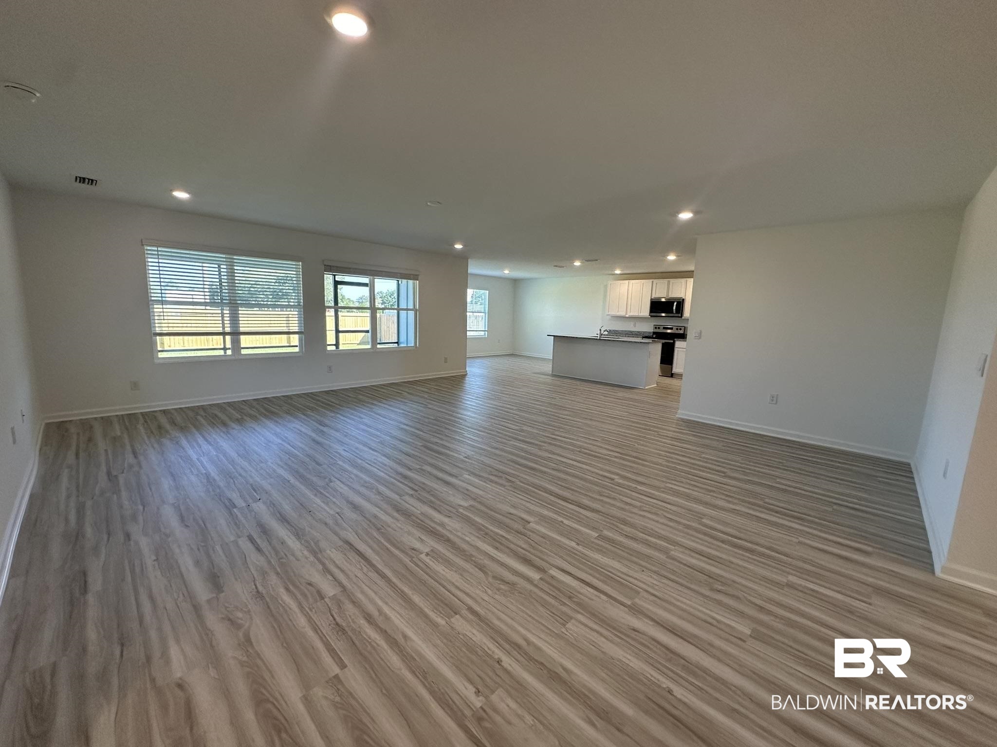 22227 Aleutian Avenue Foley, AL 36535 - Photo 6 of 64 Unfurnished living room featuring light hardwood / wood-style flooring