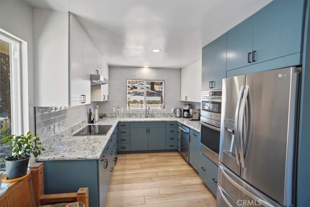 27811 Jubilee Run Road Pearblossom, CA 93553 - Photo 11 of 27 a kitchen with granite countertop a refrigerator and a sink