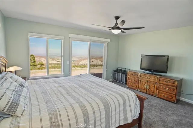 a bedroom with a bed and a flat screen television