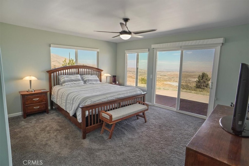 27811 Jubilee Run Road Pearblossom, CA 93553 - Photo 14 of 27 a spacious bedroom with a bed and a flat tv screen on the dresser