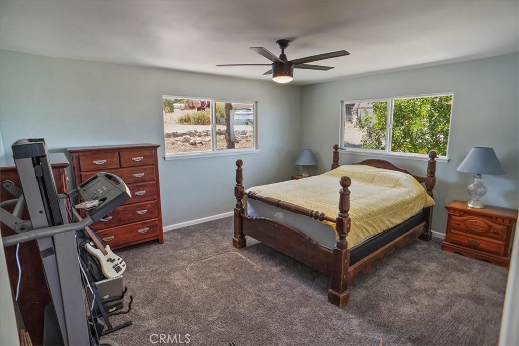 27811 Jubilee Run Road Pearblossom, CA 93553 - Photo 15 of 27 a bedroom with a bed and a flat tv screen on the dresser