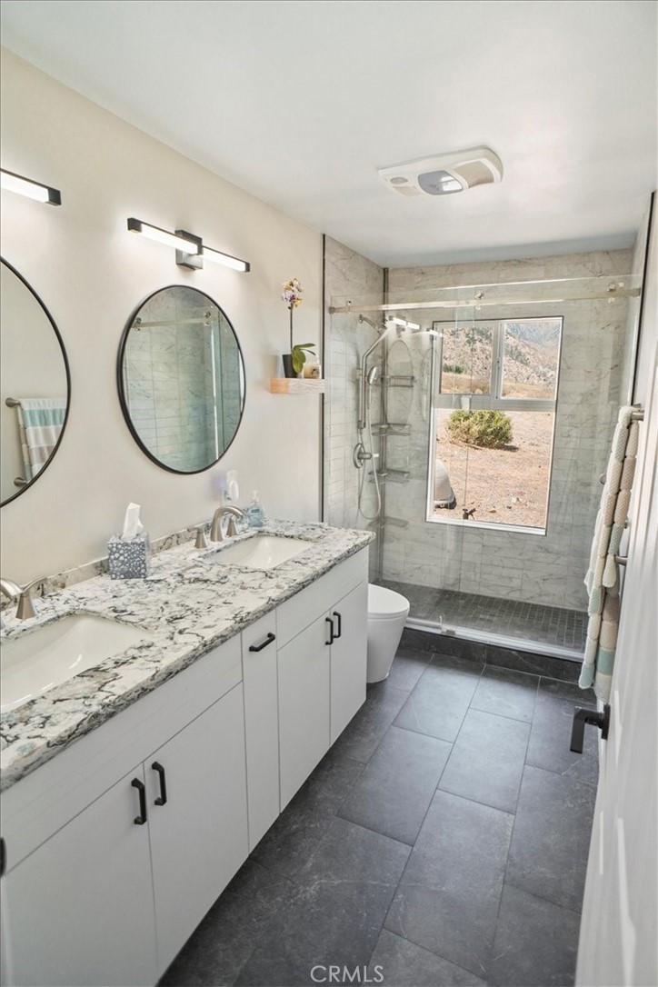 27811 Jubilee Run Road Pearblossom, CA 93553 - Photo 17 of 27 a bathroom with a granite countertop bathtub sink vanity mirror and toilet