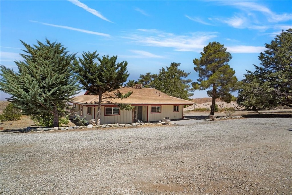27811 Jubilee Run Road Pearblossom, CA 93553 - Photo 2 of 27 a white house with a big yard and large trees