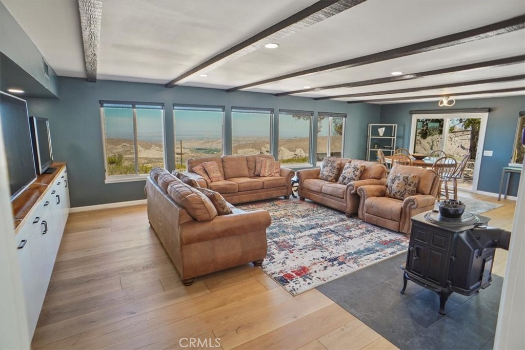 27811 Jubilee Run Road Pearblossom, CA 93553 - Photo 8 of 27 a living room with furniture large windows and wooden floor