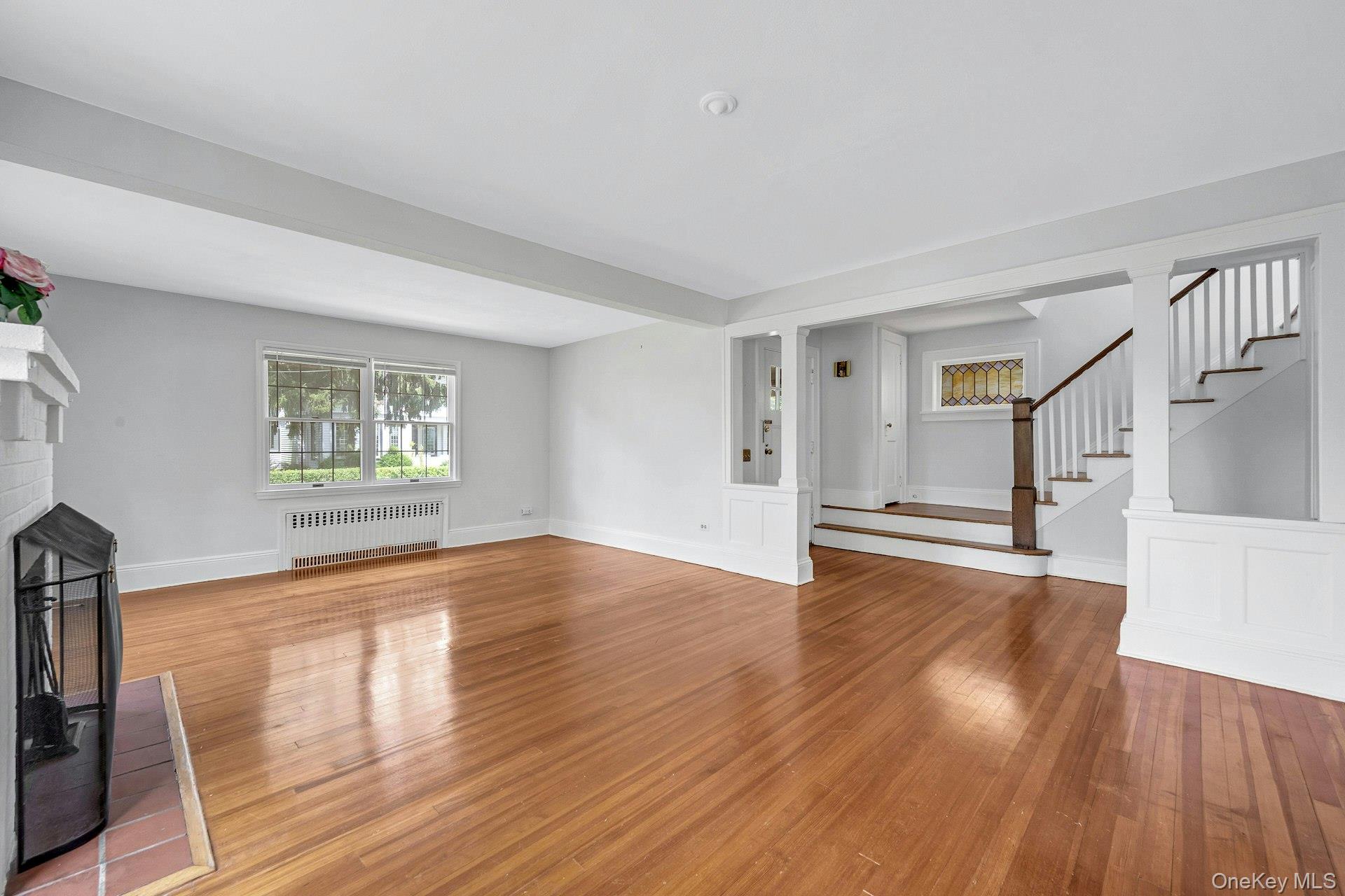 10 Carman Road Scarsdale, NY 10583 - Photo 5 of 32 Spacious Living Room with fireplaceand a brick fireplace