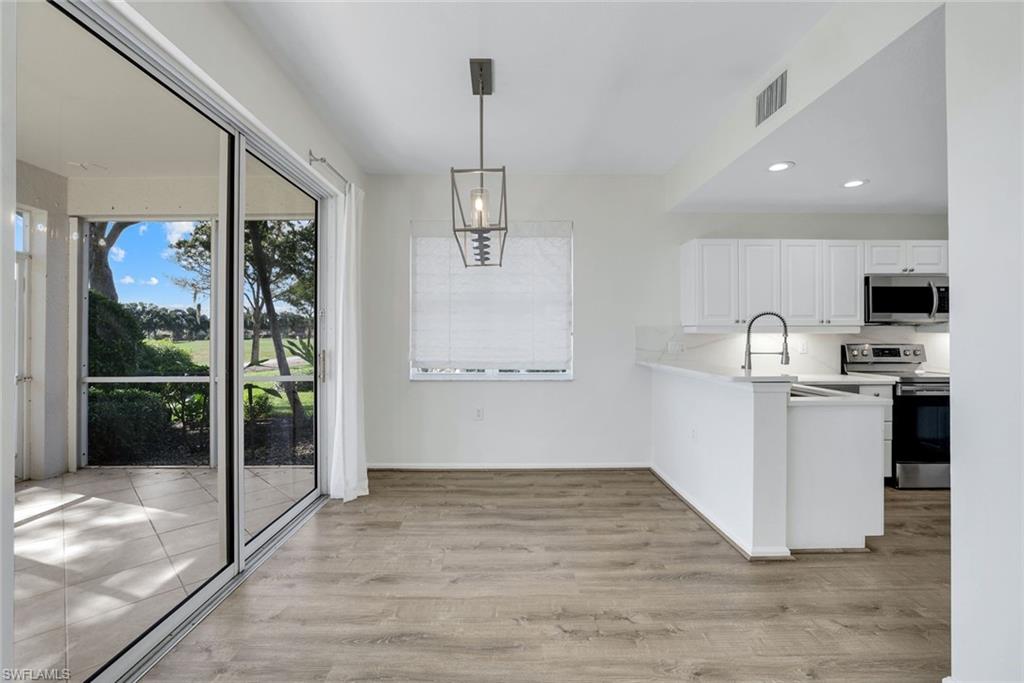 6875 Ascot Drive, Unit 6 Naples, FL 34113 - Photo 11 of 31 a view of a kitchen with a sink and a window