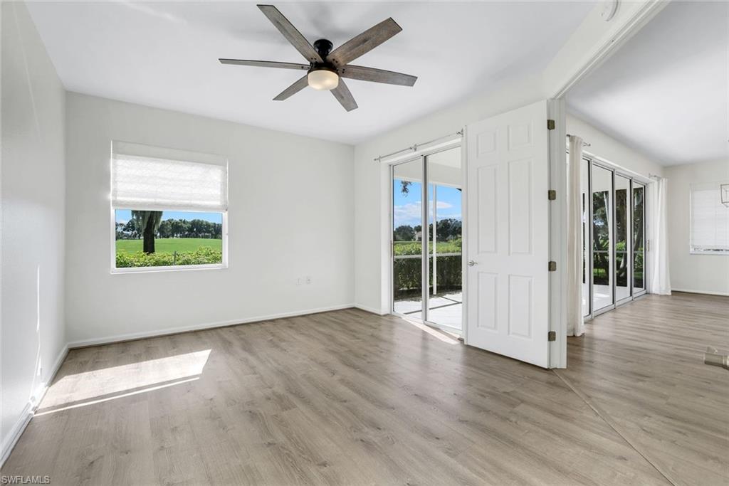 6875 Ascot Drive, Unit 6 Naples, FL 34113 - Photo 14 of 31 wooden floor in an empty room with a window