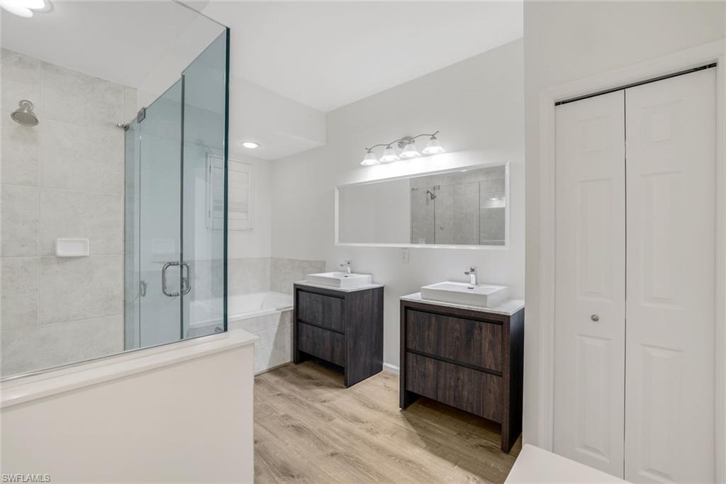 6875 Ascot Drive, Unit 6 Naples, FL 34113 - Photo 15 of 31 a bathroom with a double vanity sink mirror and shower
