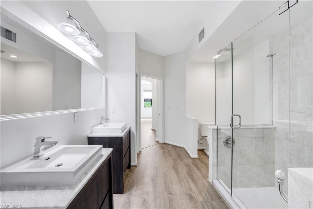 6875 Ascot Drive, Unit 6 Naples, FL 34113 - Photo 16 of 31 a en suite bathroom with a sink a toilet and shower