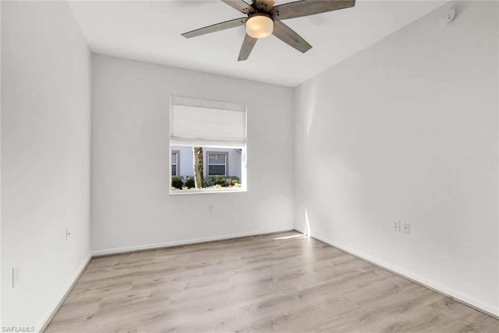 6875 Ascot Drive, Unit 6 Naples, FL 34113 - Photo 19 of 31 a view of an empty room with a window