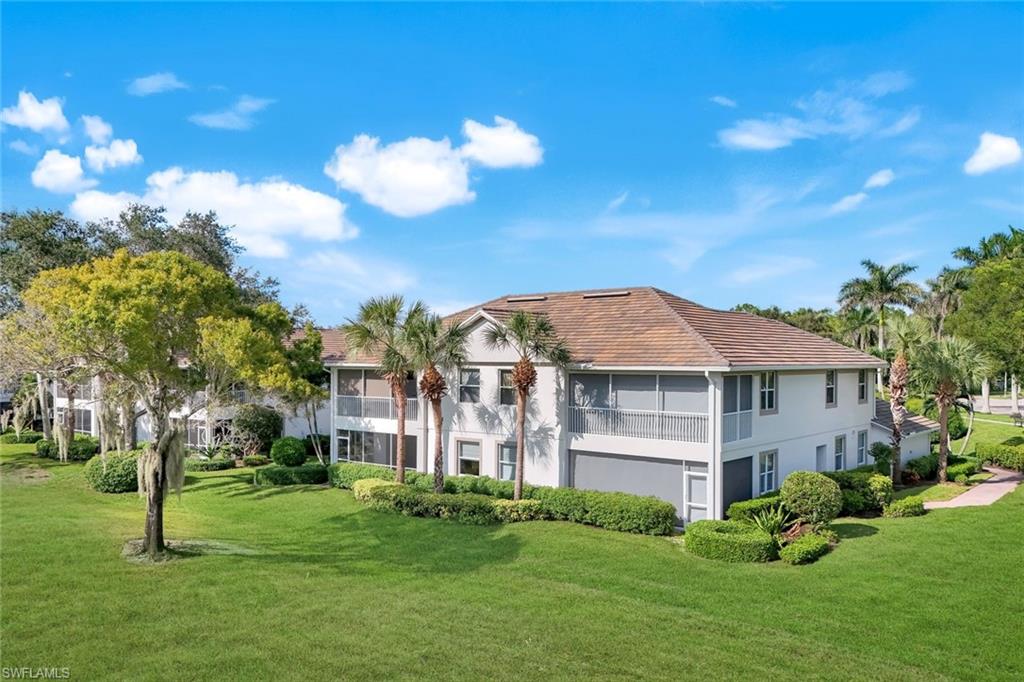 6875 Ascot Drive, Unit 6 Naples, FL 34113 - Photo 23 of 31 a front view of a house with a yard