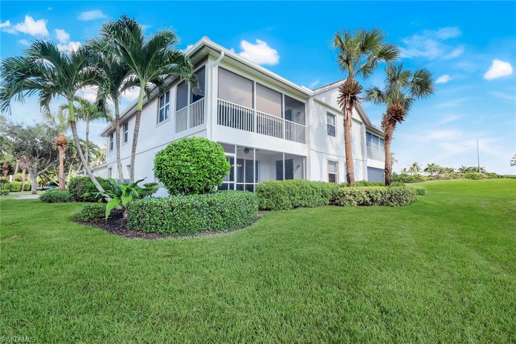 6875 Ascot Drive, Unit 6 Naples, FL 34113 - Photo 26 of 31 a front view of a house with a garden