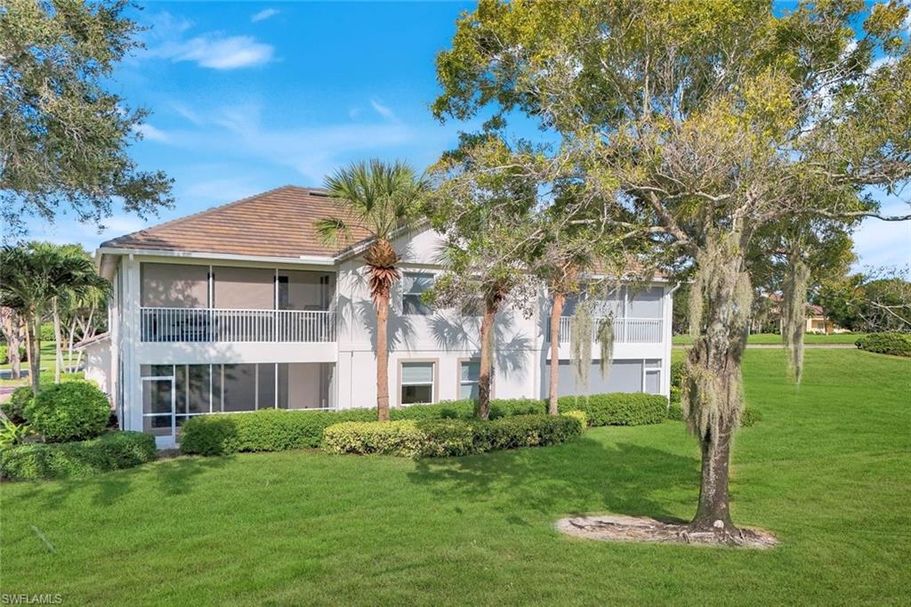 6875 Ascot Drive, Unit 6 Naples, FL 34113 - Photo 27 of 31 a front view of a house with a garden