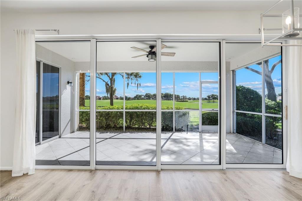 6875 Ascot Drive, Unit 6 Naples, FL 34113 - Photo 7 of 31 a view of a livingroom with a floor to ceiling window