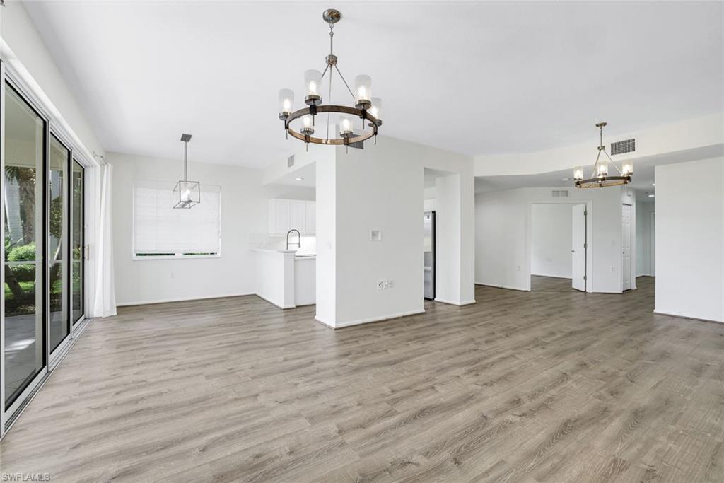 6875 Ascot Drive, Unit 6 Naples, FL 34113 - Photo 9 of 31 a view of a kitchen with a dishwasher and wooden floor