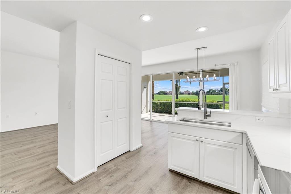 6875 Ascot Drive, Unit 6 Naples, FL 34113 - Photo 10 of 31 a kitchen with a sink window and cabinets
