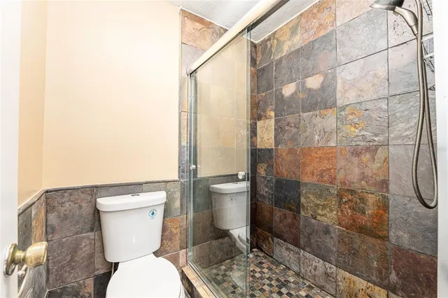 a white toilet sitting next to a bathroom sink