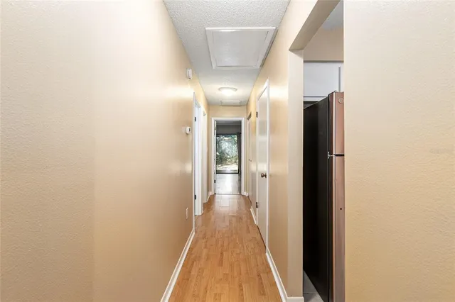 a view of a hallway with wooden floor