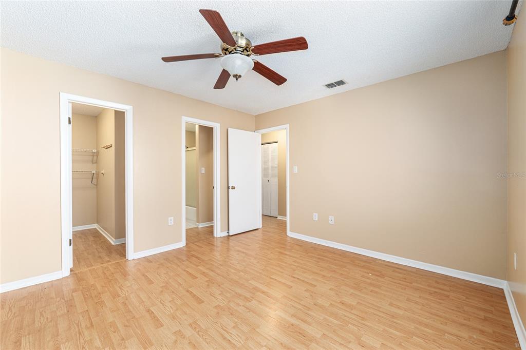 3057 Northwest 28th Circle Gainesville, FL 32605 - Photo 27 of 50 a view of a big room with wooden floor and a ceiling fan