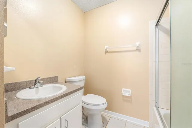 a bathroom with a sink toilet and a mirror